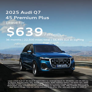 Angle view of 2025 Audi Q7 45 e-tron driving 